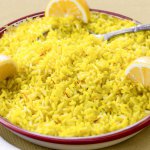 Shallow red-rimmed bowl with Saffron & Lemon Infused Basmati Rice garnished with 3 lemon wedges