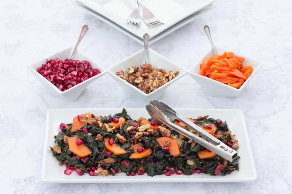 White rectangular plate with Swiss Chard & Persimmon Sautee with 3 dishes of toppings