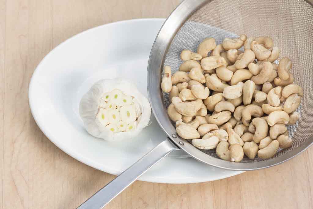 #1 Cut of top of garlic bulb; rinse and drain cashews.
