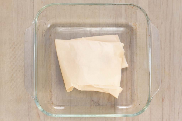 #4 Wrap the garlic bulb loosely in parchment paper and put in baking pans or sheet.