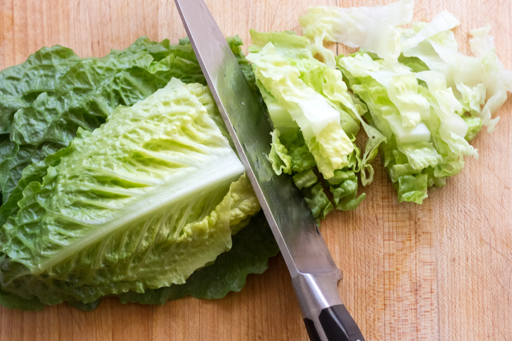 #5 Stack, roll and slice the romaine leaves into ribbons.