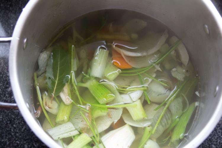 Overhead view of pot with vegetables starting to boil