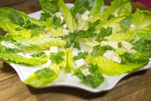 Scalloped white serving platter with Romaine Salad Boats.