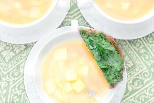Three bowls of Fresh Springtime Garlic Soup with a parsley & cilantro pesto toast