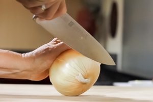 Cut the stem side off of the onion