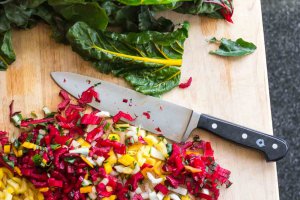 Boos Board in use with chopped rainbow Swiss Chard stems and a chef knife.