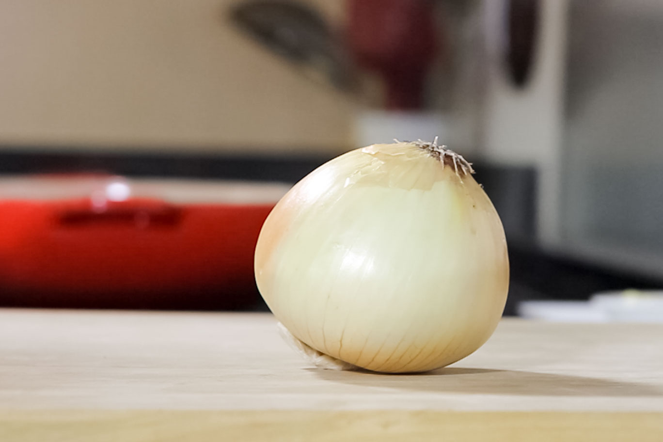 Radial Onion Dice: Onion with the root side up and stem on board ready for that radial cut