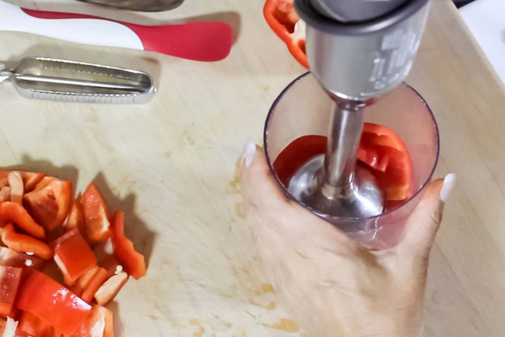 Kitchen Aid Hand Blender with a fresh red bell pepper in the cup ready to be blended.