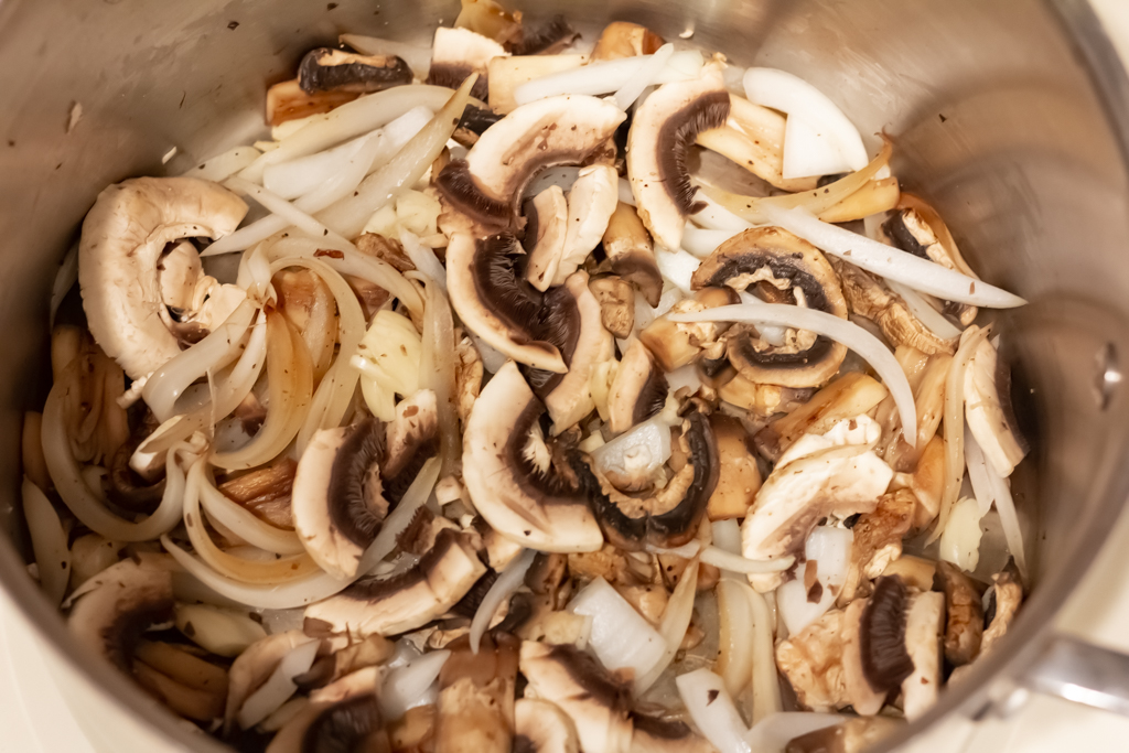 Add the remainder of the mushrooms and the garlic.