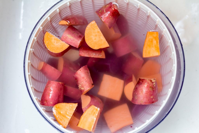 Cut sweet potatoes in a salad spinner to rinse before spicing