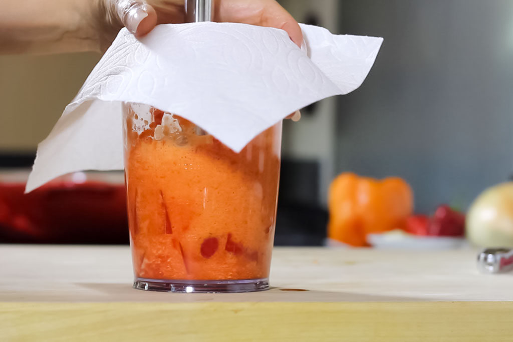 04 Cover the blender cup with a paper towel and blend the peppers until smooth