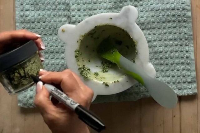 Writing the date on the pesto jar with a sharpie pen